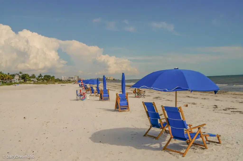line of blue lounge chairs under blue umbrella at Sandpiper Gulf Resort Florida