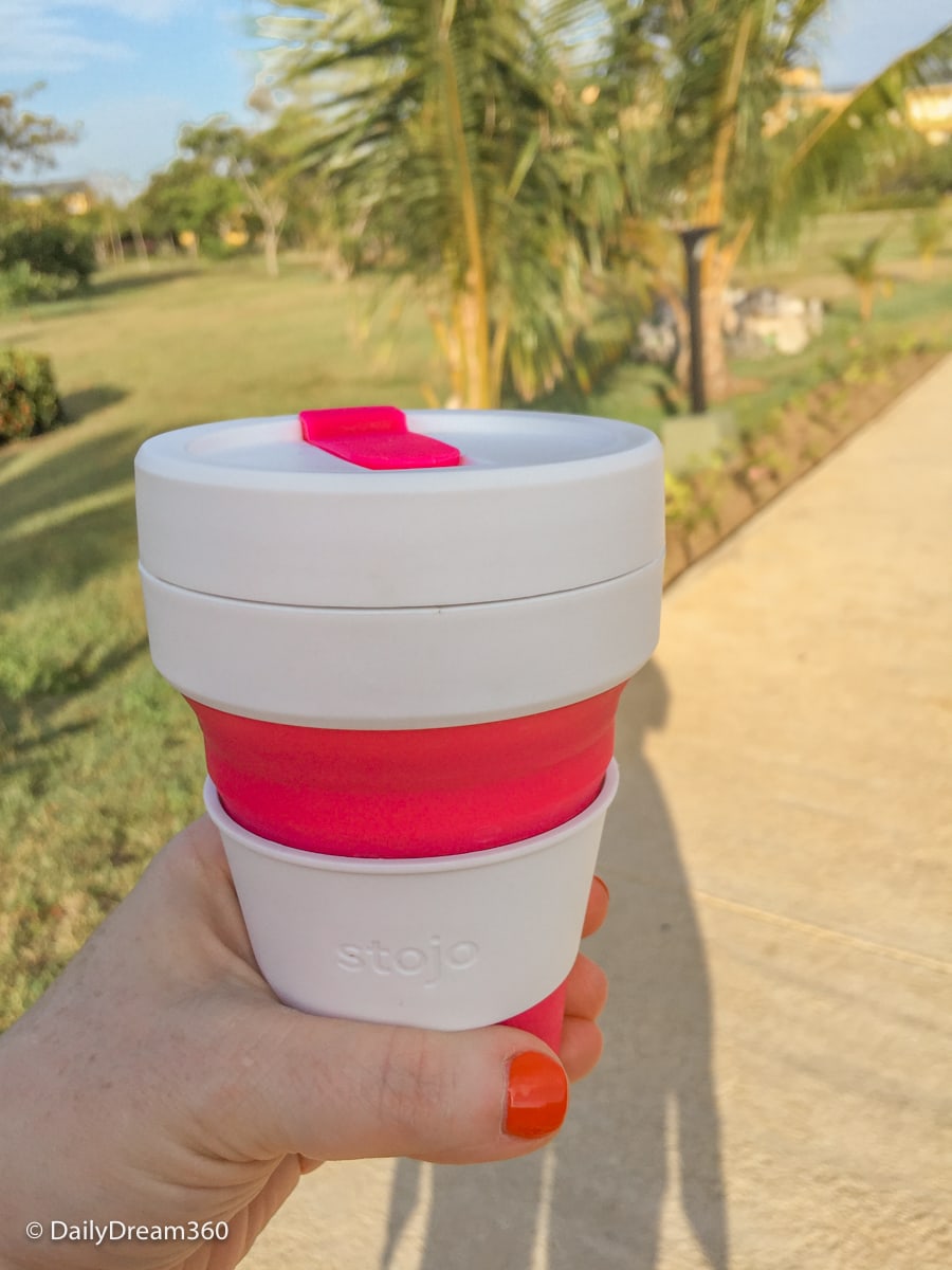 Walking on path in Cuba with stojo pocket cup