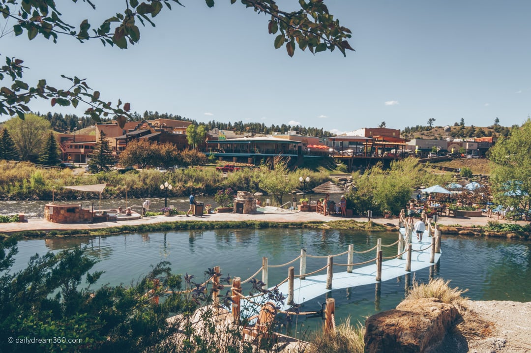 Blue bridge sneaks across mineral pool and wide angle look at Pagosa Springs hot springs