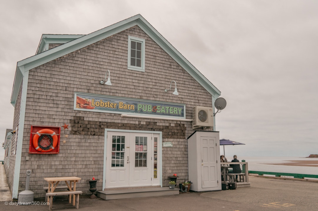 Lobster Barn building on pier in Victoria by the Sea Popular PEI Road Trip stops to the beaches of West Point